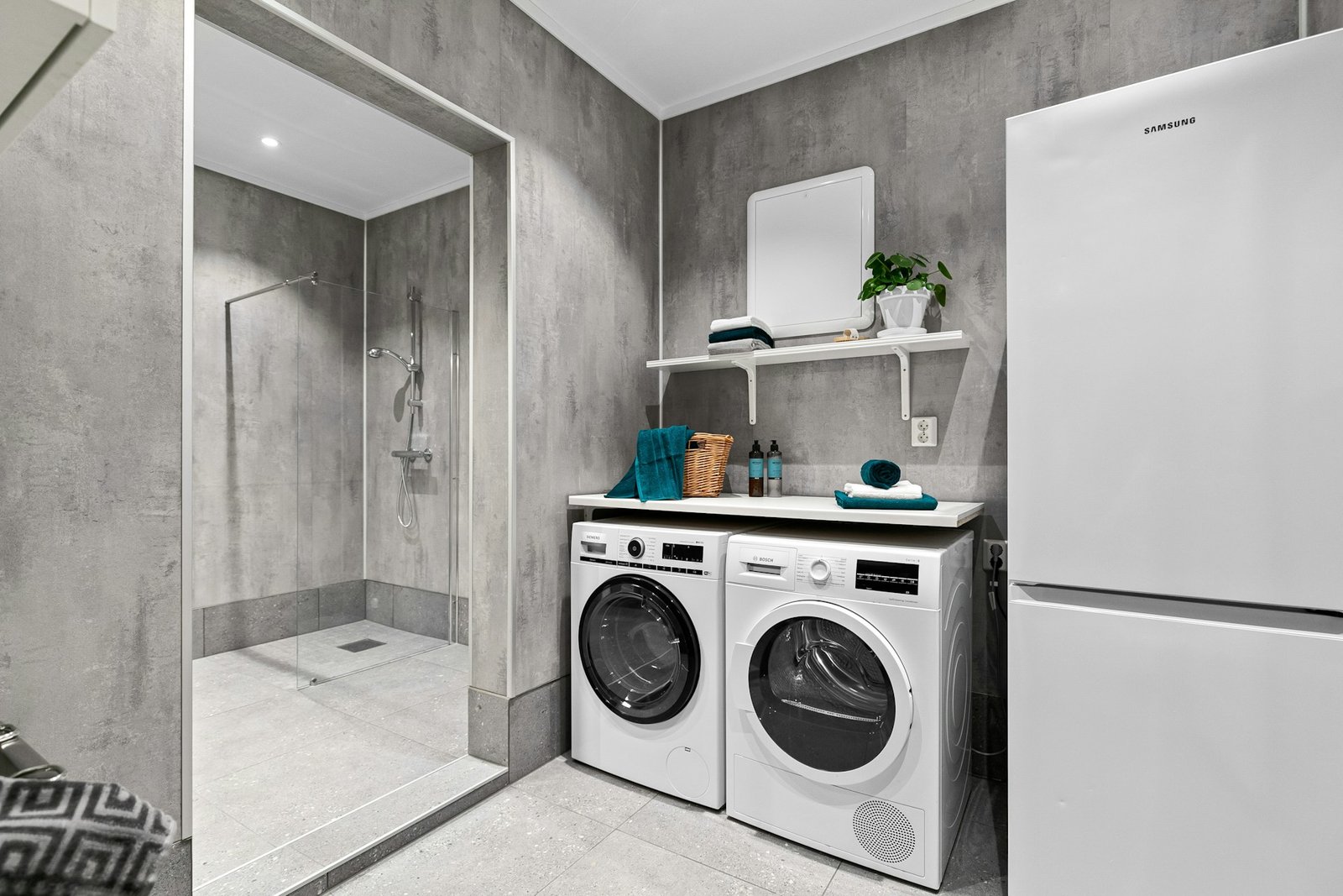 Waschmaschine in einem kleinen Hauswirtschaftsraum mit gefliestem Boden